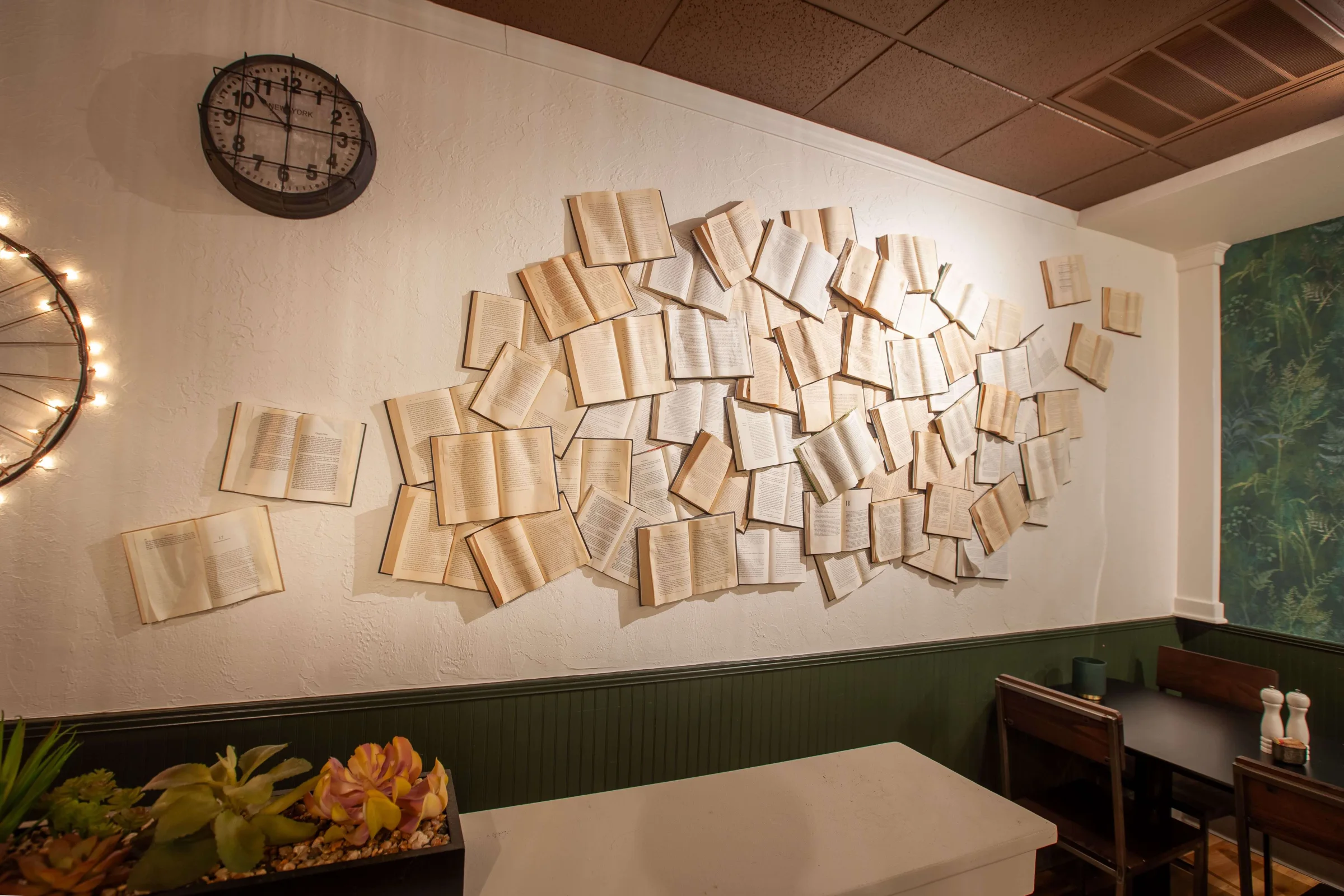 A wall of open books arranged as art in the Scuola dining room